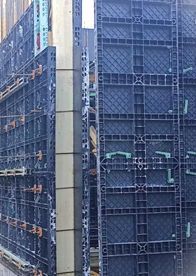 Stop-end wall formwork using wooden board and beams on construction site